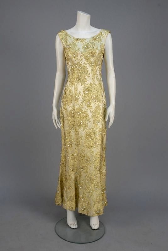 Appraisal: MIGNON PARIS BEADED BROCADE EVENING GOWN s Sleeveless ivory silk