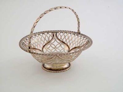 Appraisal: A Victorian pierced circular bonbon basket with a pierced swing