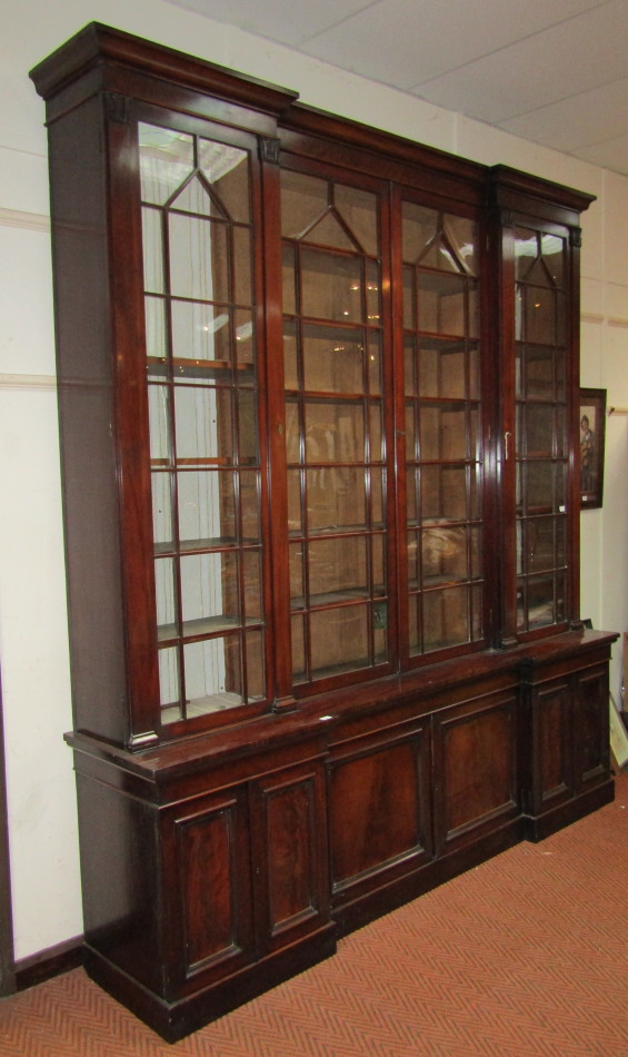 Appraisal: An early Victorian mahogany breakfront cabinet bookcase with moulded cornice