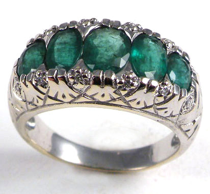 Appraisal: EMERALD AND FOURTEEN KARAT GOLD RING set with five oval-cut