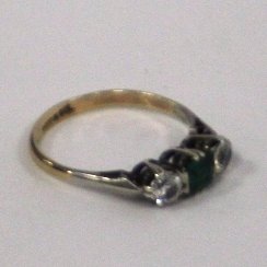 Appraisal: A three-stone ring the central emerald flanked by two paste