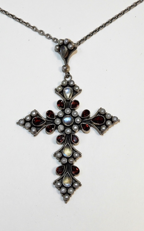 Appraisal: NICKY BUTLER STERLING SILVER GARNET CRUCIFIX CROSS ContemporarySterling silver crucifix