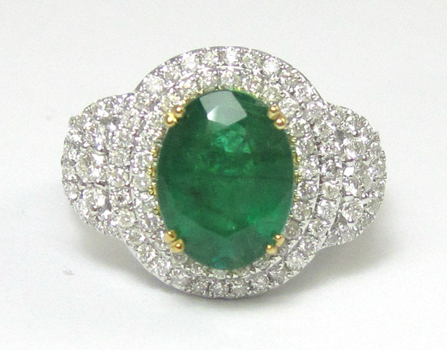 Appraisal: EMERALD DIAMOND AND FOURTEEN KARAT WHITE GOLD DINNER RING centering