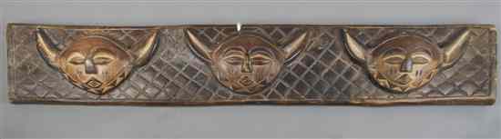 Appraisal: A Carved Lintel Pende with three repeating faces on a