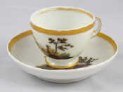 Appraisal: A Russian porcelain cup and saucer hand painted with country