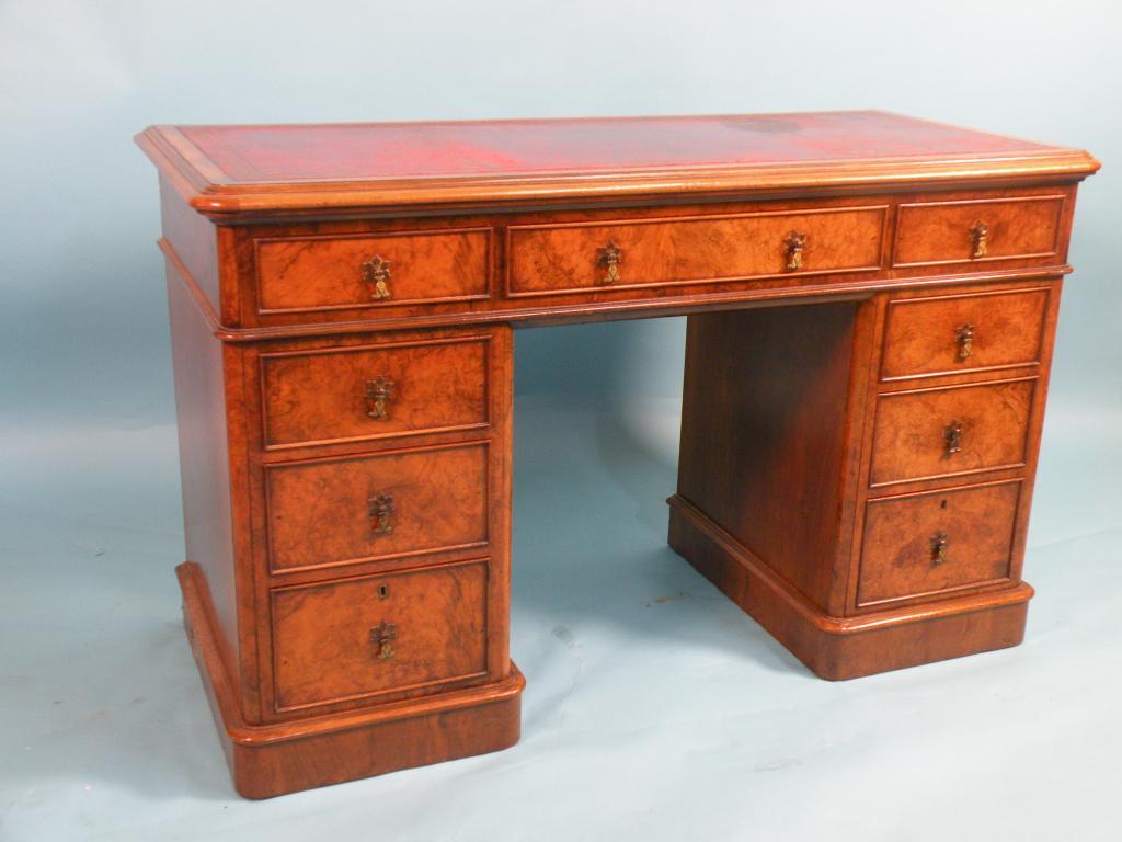 Appraisal: A Victorian burr walnut pedestal desk rectangular top with a