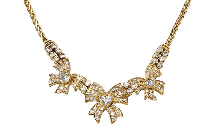 Appraisal: A contemporary diamond set necklace the central bow and heart