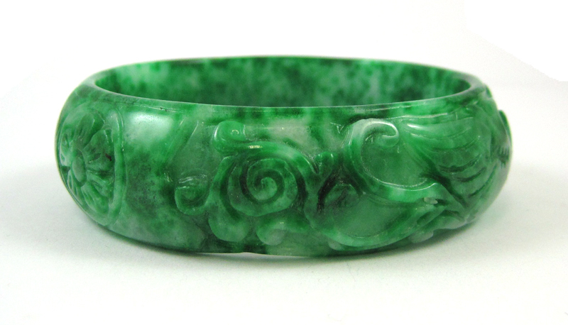 Appraisal: CARVED GREEN JADE BANGLE weighing grams and measuring inches wide