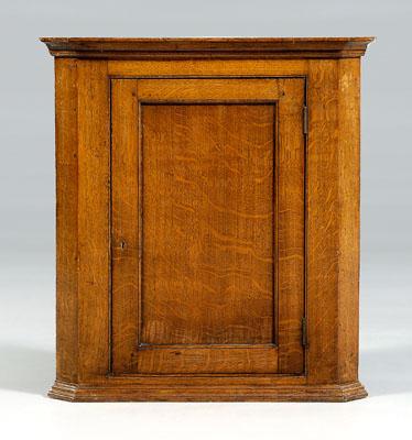 Appraisal: Georgian oak hanging corner cupboard panel door opening to shelved