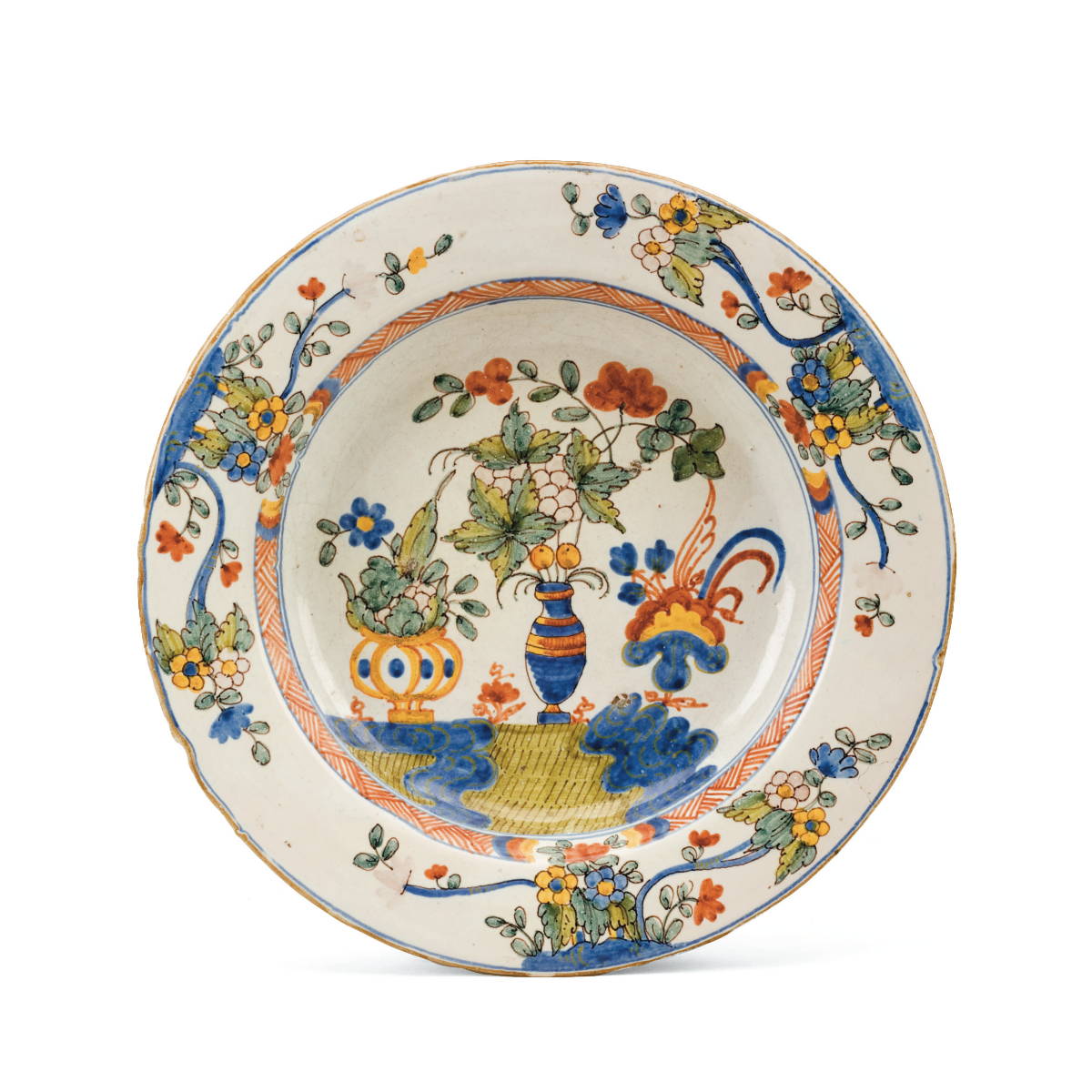 Appraisal: DELFT POLYCHROME SOUP PLATE Painted with a vase issuing fruiting