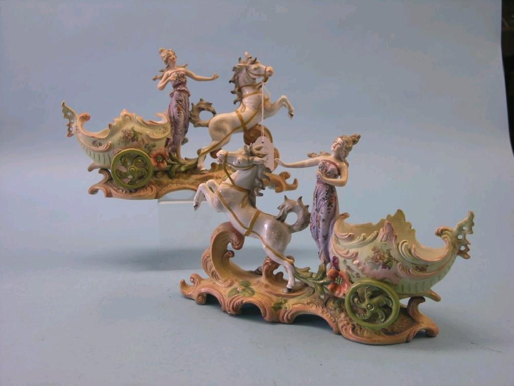 Appraisal: A pair of French bisque porcelain chariot models each horse-drawn