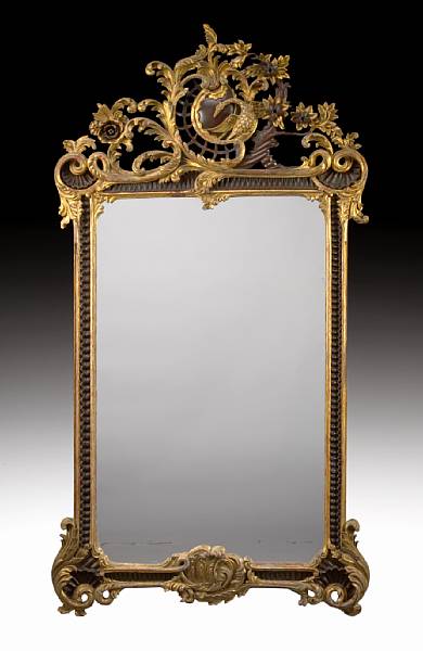 Appraisal: A Continental Rococo style carved mahogany and parcel gilt mirror