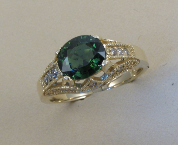 Appraisal: GREEN TOURMALINE AND DIAMOND RING k yellow gold and centering