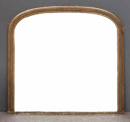 Appraisal: A th Century gilt overmantel mirror with arched top and