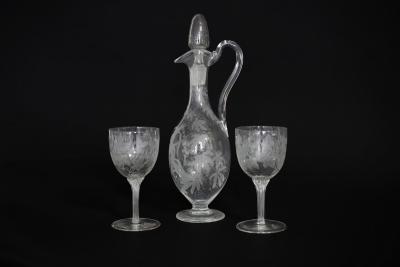 Appraisal: A Victorian etched glass ewer and two matching glasses