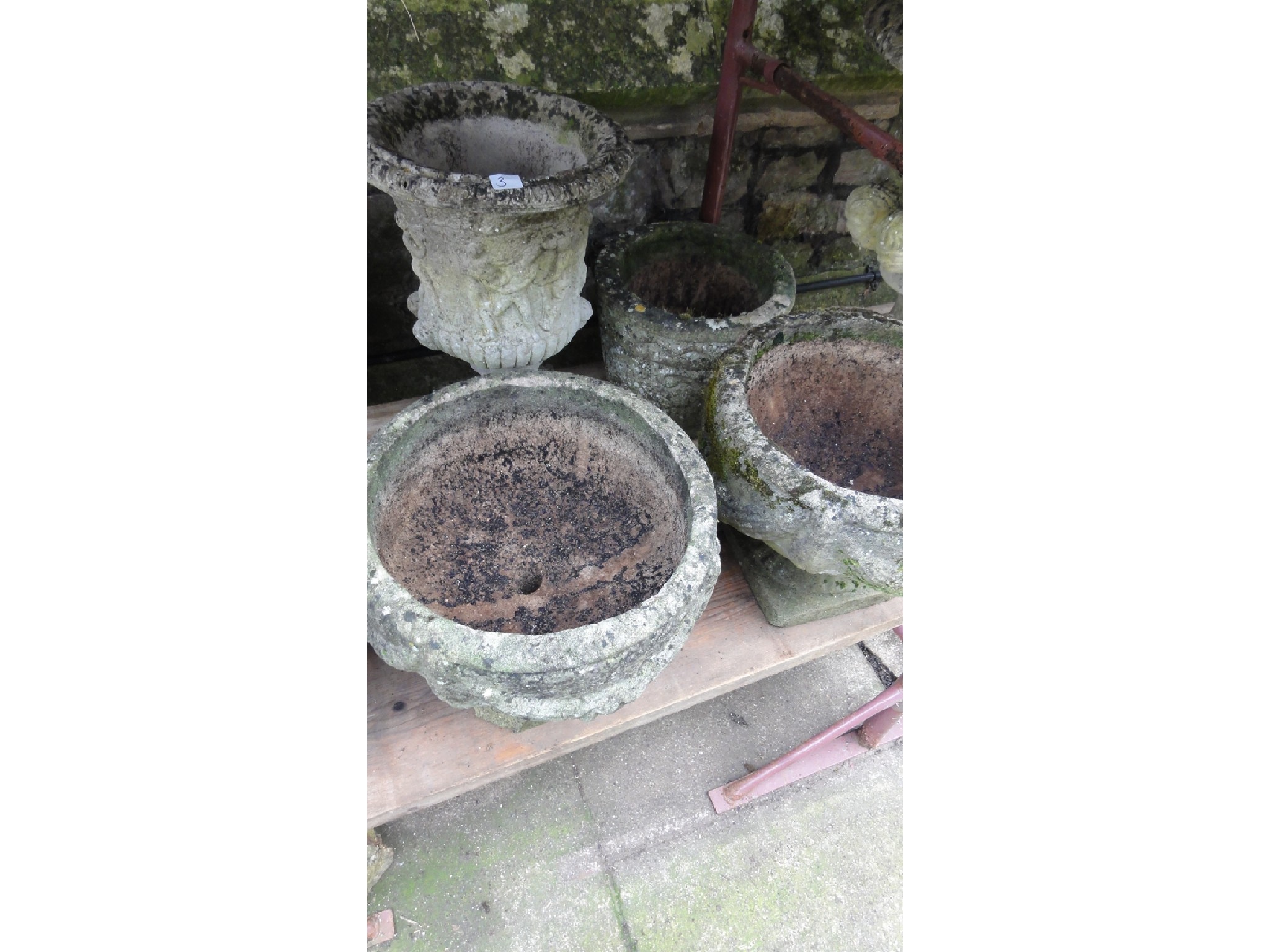 Appraisal: A pair of weathered cast composition stone garden urns of