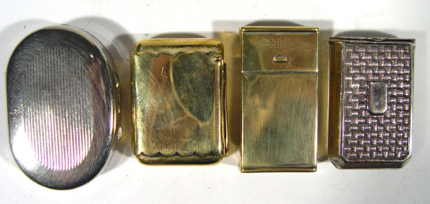 Appraisal: Two white metal vestas a brass vesta and a gilette