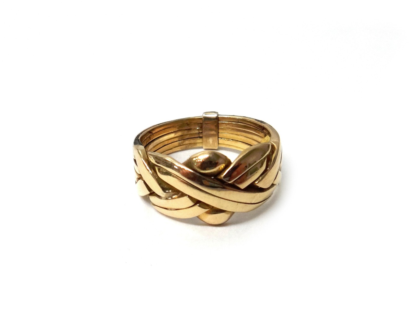 Appraisal: A gold puzzle ring in a multiple section design bound