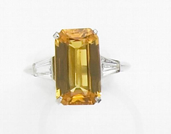 Appraisal: Yellow Sapphire and Diamond Ring A vibrant golden yellow stone