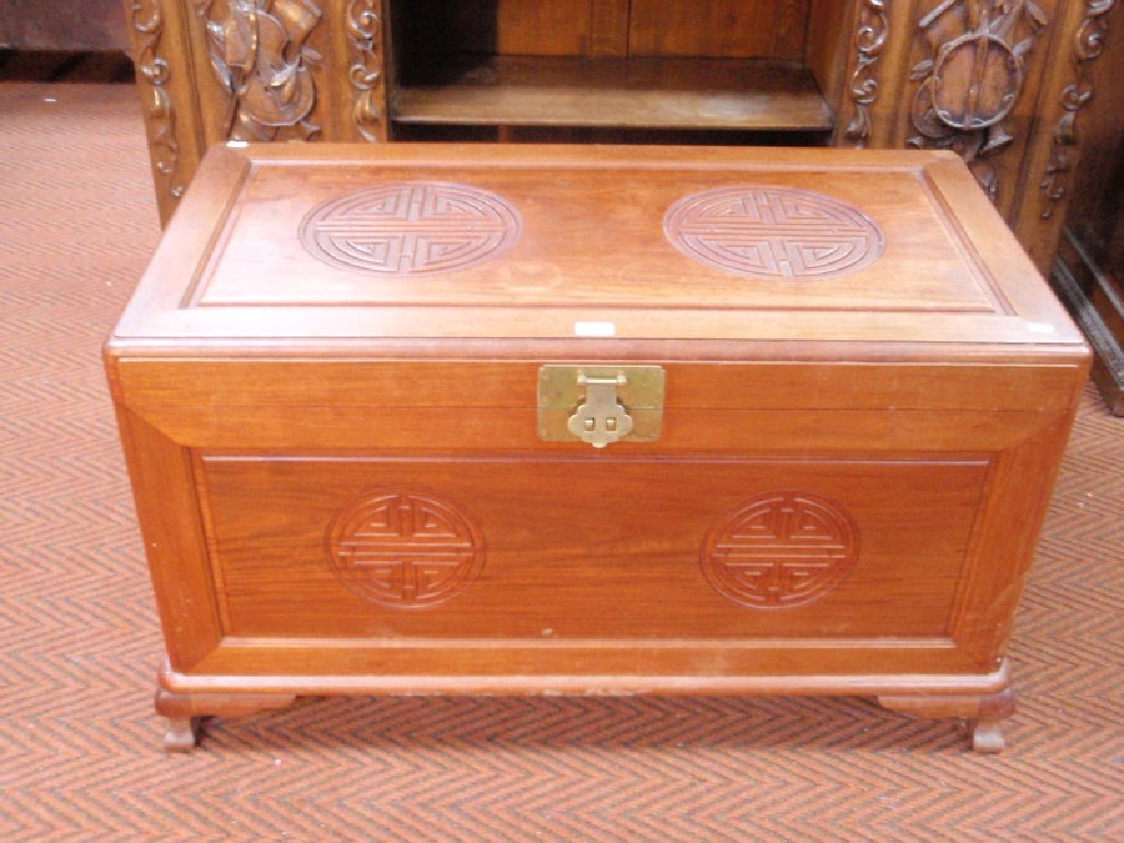 Appraisal: A Chinese camphor wood chest with hinged panelled lid and