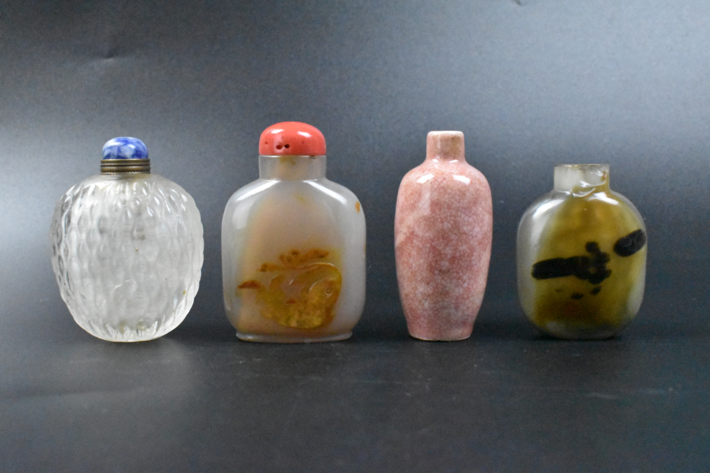 Appraisal: Four Chinese snuff bottles agate porcelain and crystal The porcelain