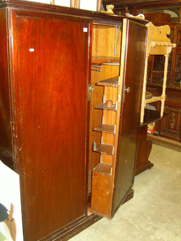 Appraisal: An early th century mahogany compactum wardrobe enclosed by a