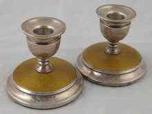 Appraisal: A pair of enamelled silver dwarf candlesticks Birmingham