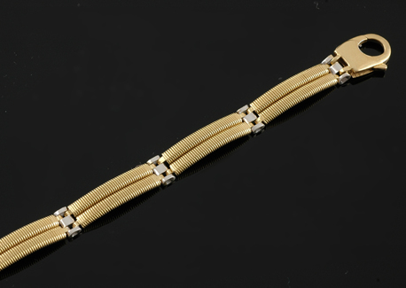 Appraisal: A modern two tone gold bracelet Comprising yellow gold curved