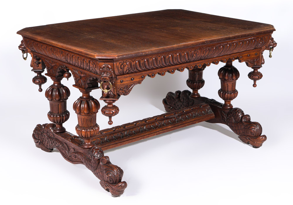 Appraisal: GOTHIC REVIVAL OAK CARVED LIBRARY TABLE Rectangular top with canted