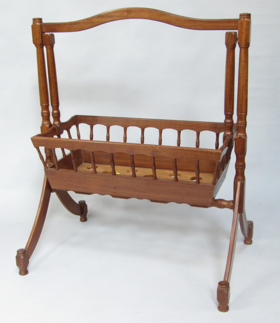 Appraisal: A Victorian style hardwood cradle raised on an open frame