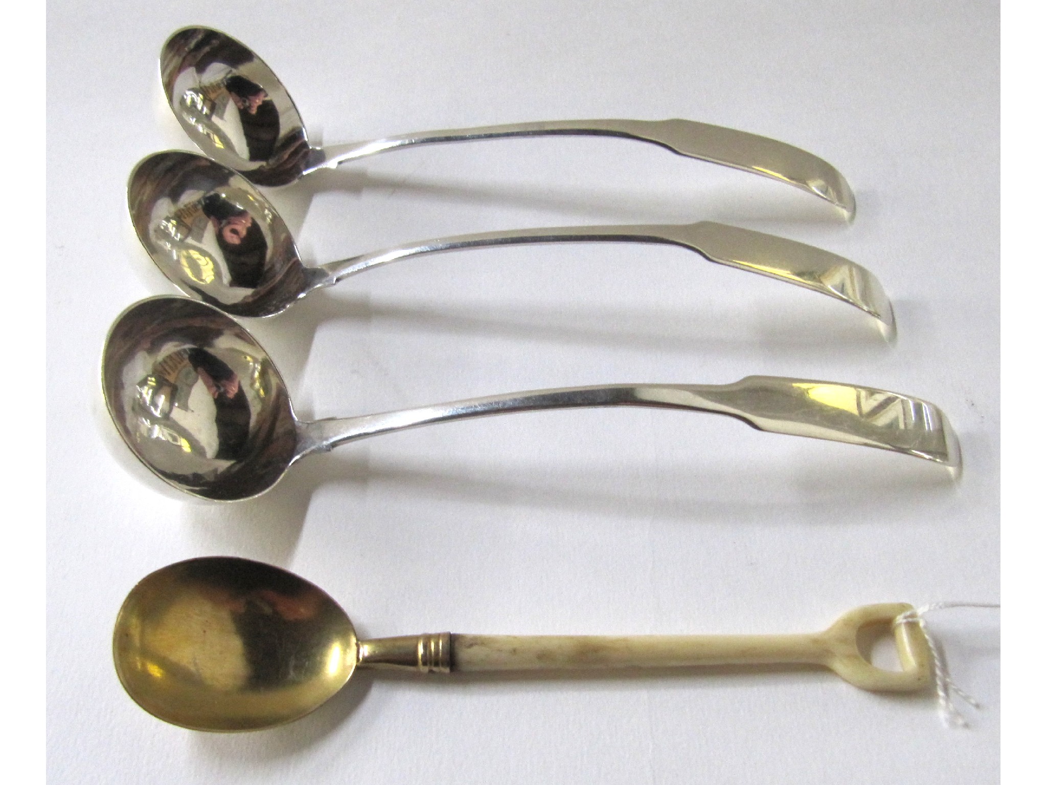 Appraisal: A set of three silver sauce ladles Edinburgh and a