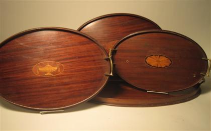 Appraisal: Six Edwardian inlaid mahogany serving traysearly th century