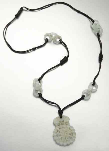 Appraisal: Chinese Qing carved white jade necklacewith a jade pendant depicting