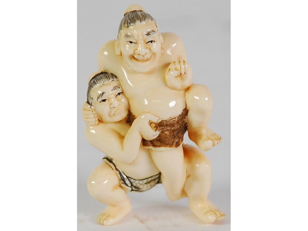 Appraisal: TWENTIETH CENTURY JAPANESE CARVED IVORY NETSUKE OF MALE WRESTLERS unsigned