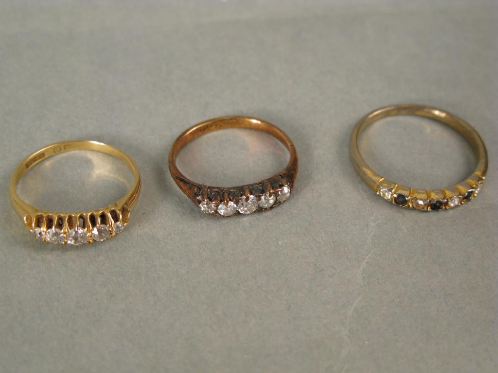 Appraisal: Two ct gold rings each claw-set with five small diamonds