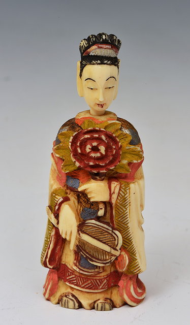 Appraisal: A JAPANESE PAINTED IVORY SNUFF BOTTLE of a girl holding