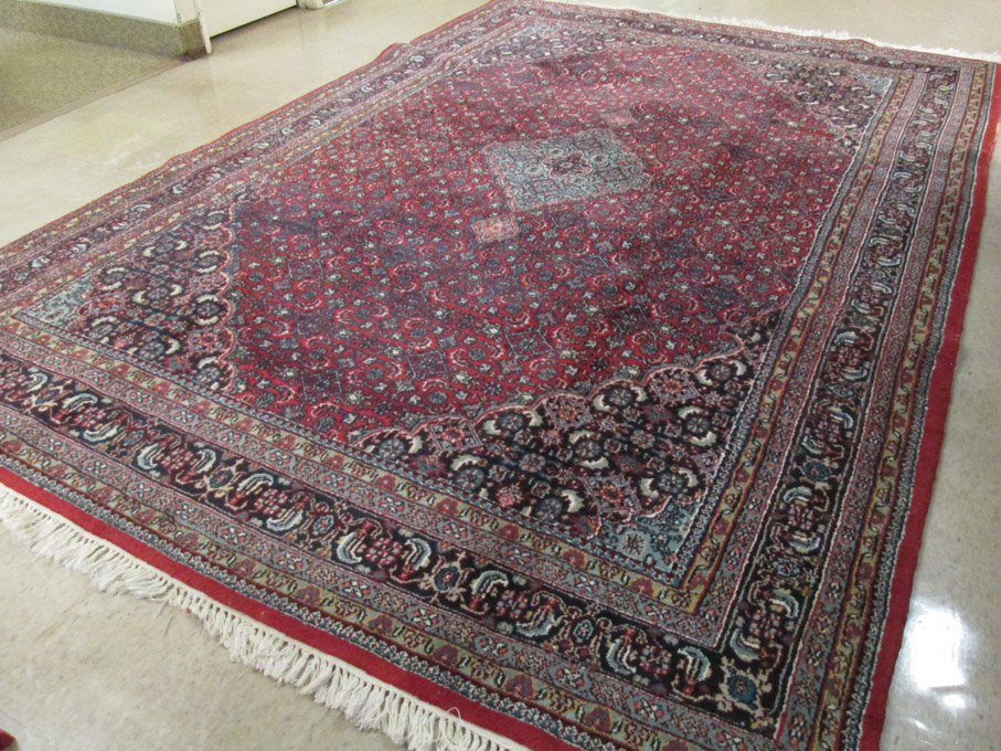 Appraisal: HAND KNOTTED ORIENTAL CARPET Indo-Bijar central medallion and Herati floral