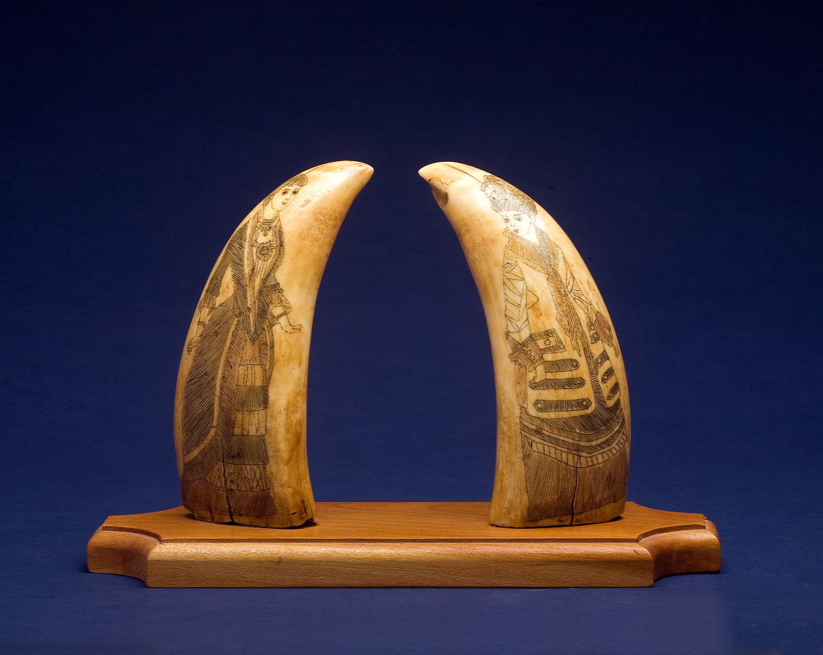 Appraisal: PAIR OF SCRIMSHAW AND POLYCHROME WHALE'S TEETH Each depicting a