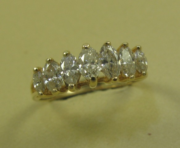 Appraisal: DIAMOND AND FOURTEEN KARAT GOLD RING set with a row