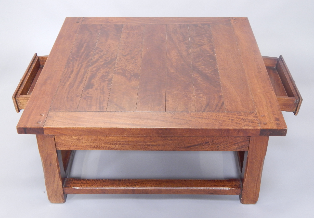 Appraisal: A hardwood coffee table the square planked top above two