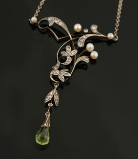 Appraisal: An Edwardian peridot diamond and seed pearl pendant The pendant