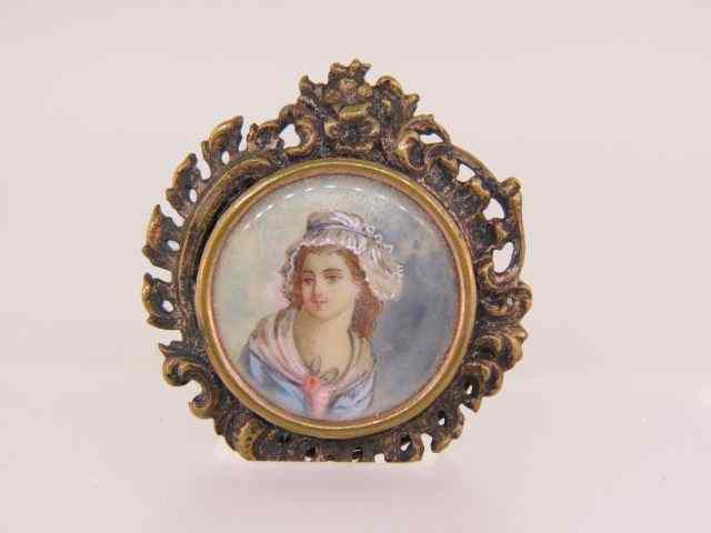 Appraisal: Miniature Painting on Ivory Broochof young maiden ornate frame French