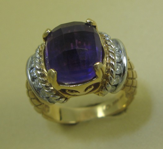 Appraisal: AMETHYST AND FOURTEEN KARAT GOLD RING centering a cushion shaped