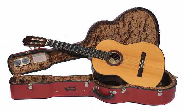 Appraisal: A PAUL FISCHER SPANISH ACOUSTIC GUITAR in a red Pegasus