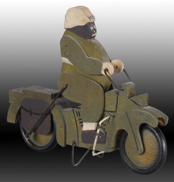 Appraisal: Folk Art MP Motorcycle Toy Description Black driver Push-toy Pre