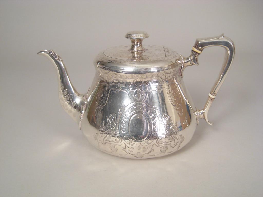 Appraisal: A Victorian circular Teapot with engraved decoration and vacant oval