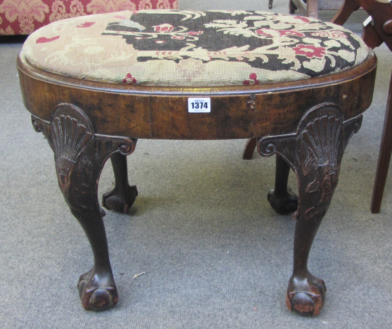 Appraisal: An th century walnut oval footstool on shell capped ball