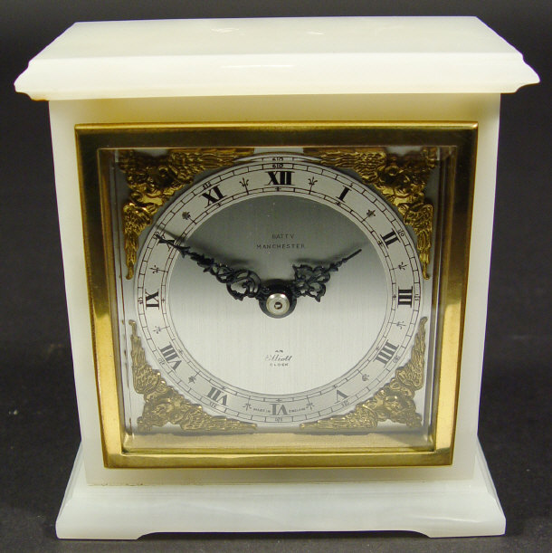 Appraisal: White marble cased Elliott mantel clock with brass cherub design