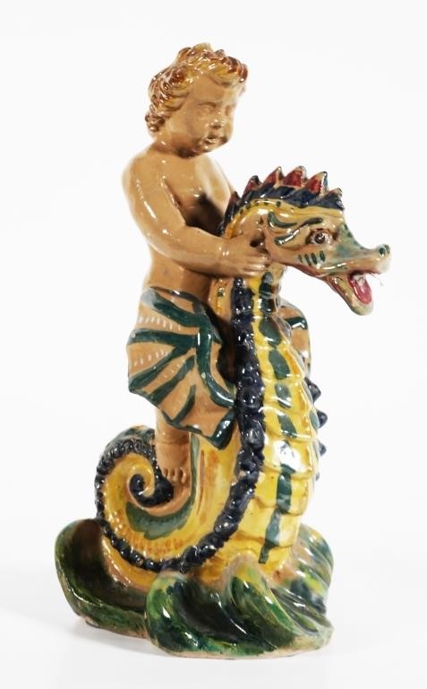 Appraisal: Antique European high statue of putti riding a dragon-winged seahorse