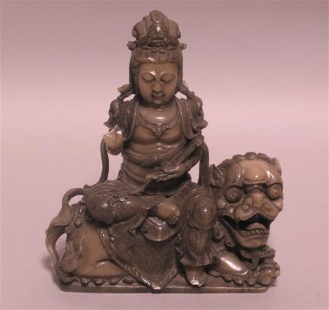 Appraisal: FINE HARDSTONE CARVING OF GUANYIN AND A BUDDHISTIC LION Well